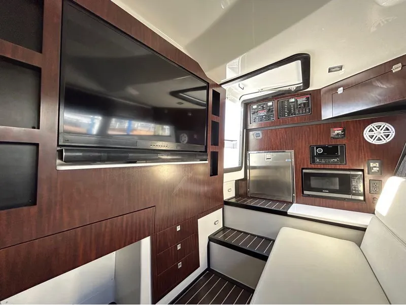 Slide: The Image of Interior of 2019 Monterey 385 SE yacht with TV, microwave, and control panel. - 24
