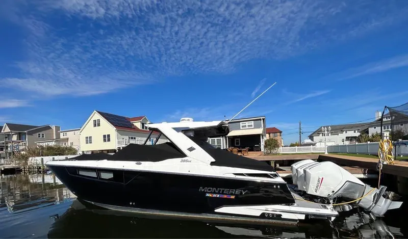 Slide: The Image of 2019 Monterey 385 SE boat docked in a residential marina. - 28