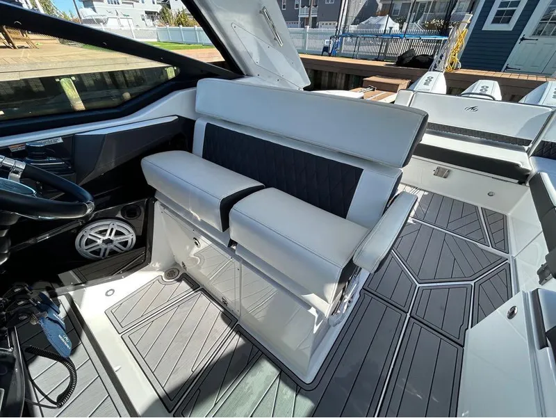 Slide: The Image of 2019 Monterey 385 SE boat interior with white and black seating. - 8