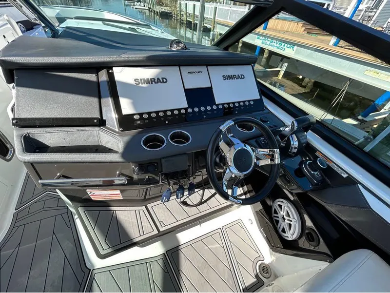 Slide: The Image of 2019 Monterey 385 SE boat dashboard with Simrad navigation system and modern controls. - 9