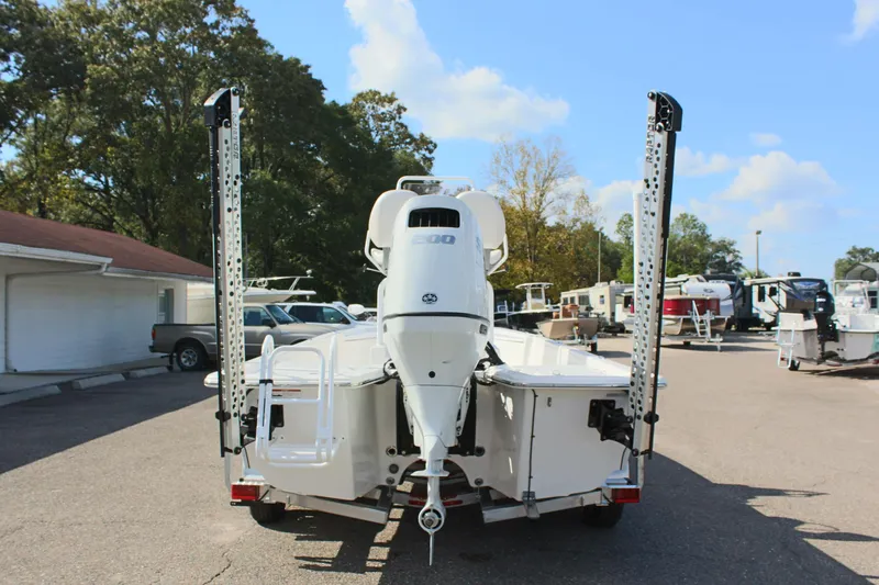 Slide: The Image of 2024 Blue Wave 2200 STL boat, rear view, in a marina parking lot. - 15