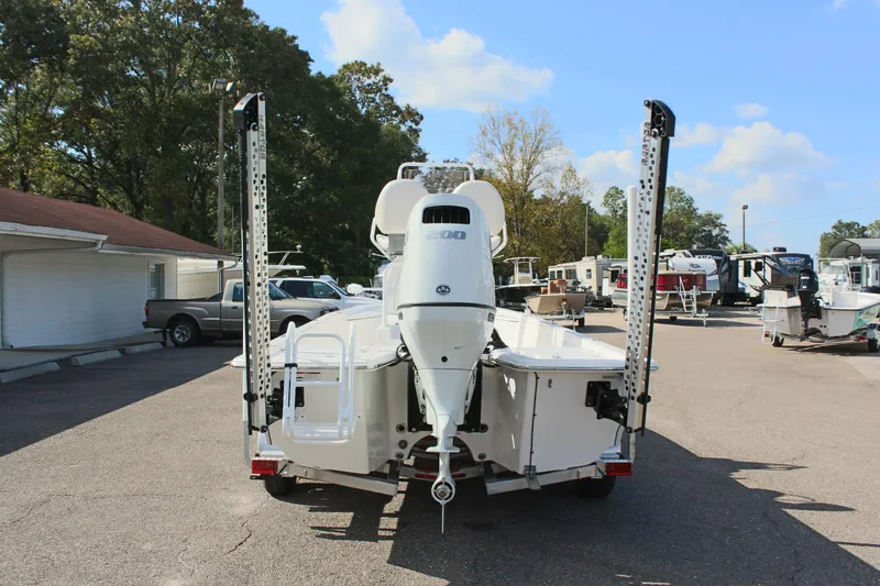 Slide: The Image of 2024 Blue Wave 2200 STL boat on trailer, rear view in outdoor setting. - 16
