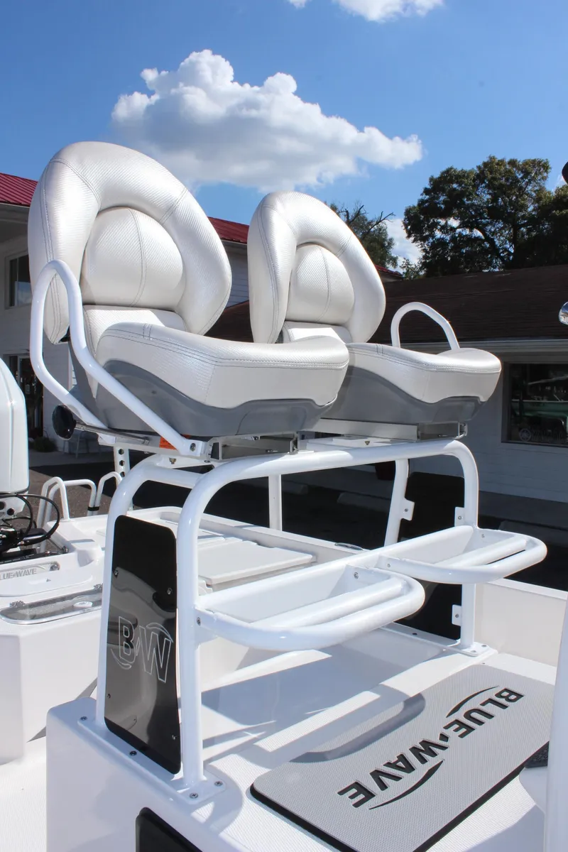 Slide: The Image of 2024 Blue Wave 2200 STL boat with dual captain's chairs and footrests. - 37