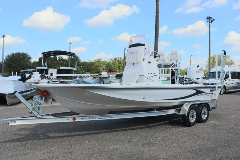 Slide: The Image of 2024 Blue Wave 2200 STL boat on a trailer in a parking lot. - 4