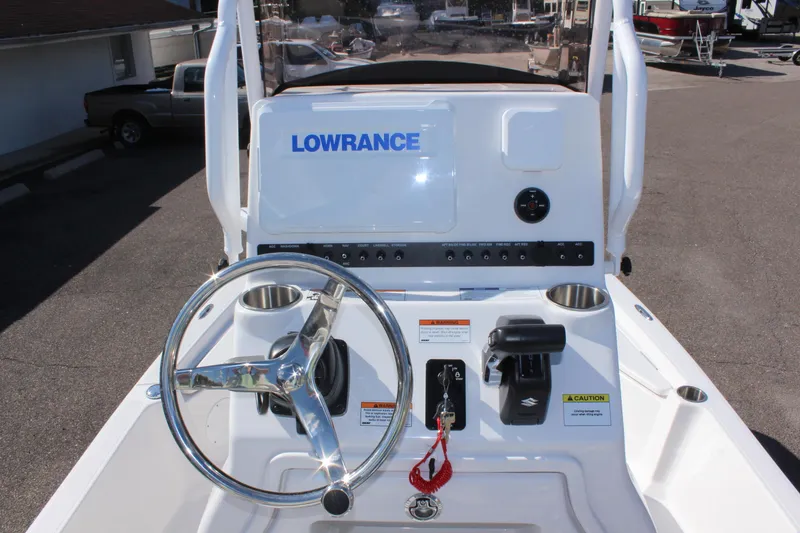 Slide: The Image of 2024 Blue Wave 2200 STL boat console with Lowrance electronics and steering wheel. - 40