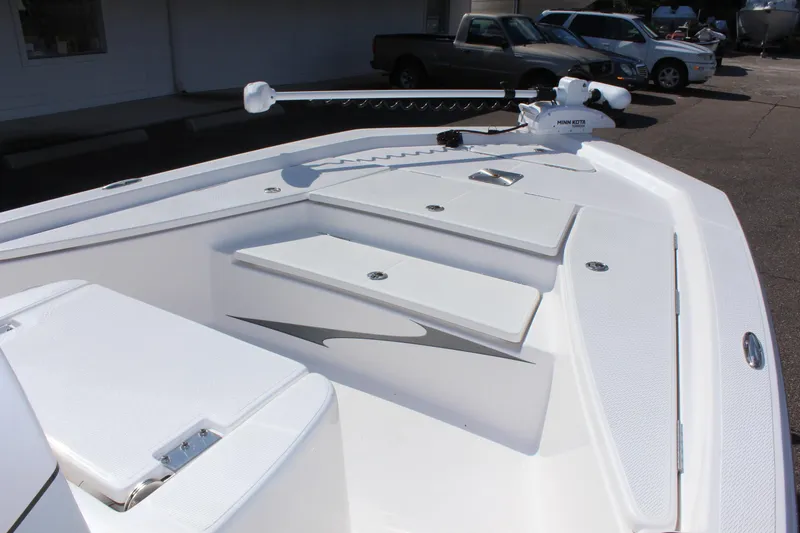 Slide: The Image of 2024 Blue Wave 2200 STL boat deck with storage compartments and trolling motor. - 47