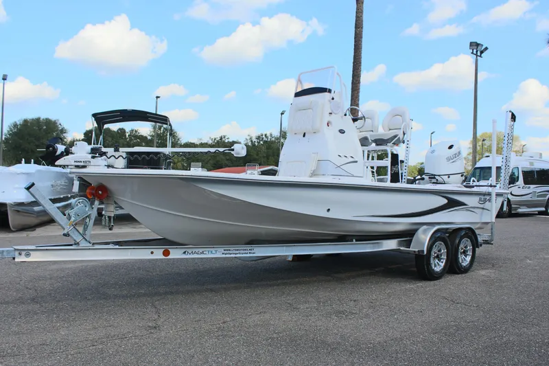 Slide: The Image of 2024 Blue Wave 2200 STL boat on a trailer under a blue sky with clouds. - 5