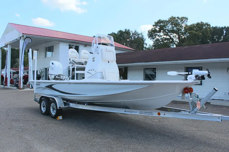 Slide: The Image of 2024 Blue Wave 2200 STL boat on a trailer outside a building. - 7
