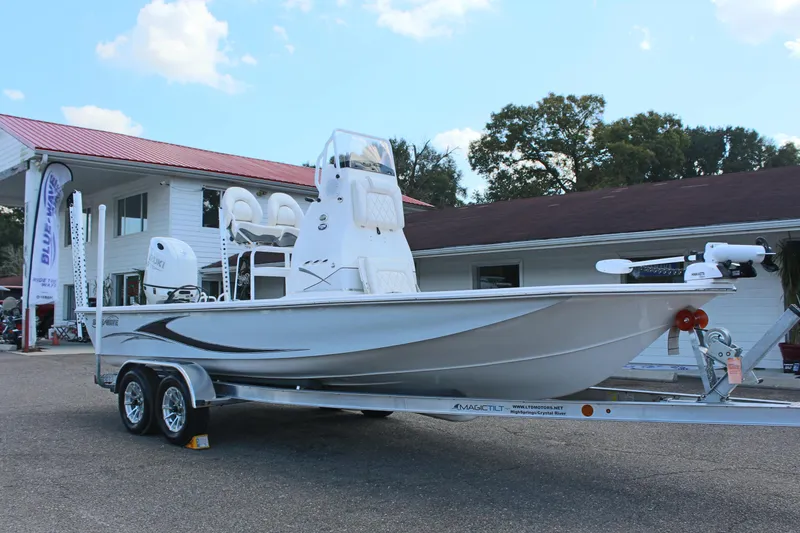 Slide: The Image of 2024 Blue Wave 2200 STL boat on a trailer outside a building. - 8