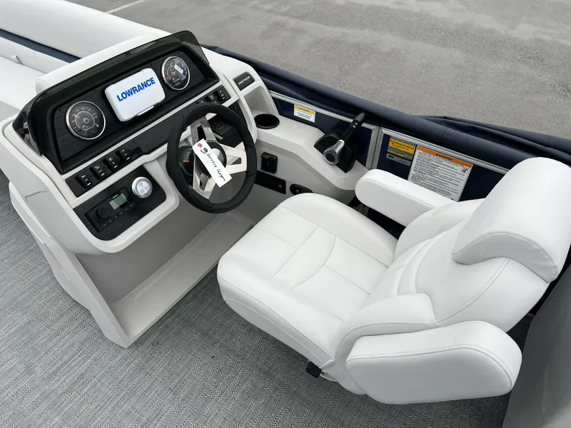 Slide: The Image of 2024 Godfrey SWEETWATER 2286 SB boat helm with white captain's chair and Lowrance display. - 14