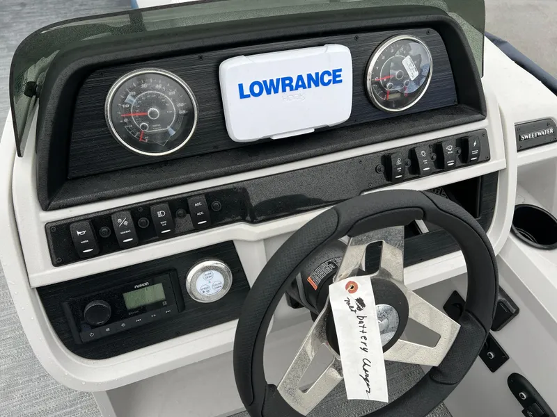 Slide: The Image of 2024 Godfrey SWEETWATER 2286 SB dashboard with Lowrance display and steering wheel. - 15