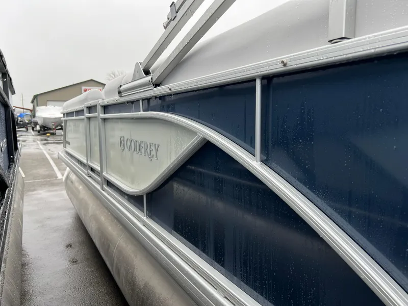 Slide: The Image of 2024 Godfrey SWEETWATER 2286 SB pontoon boat in a wet marina. - 2