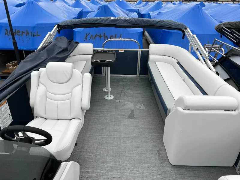 Slide: The Image of 2024 Godfrey SWEETWATER 2286 SB pontoon boat interior with seating and table. - 7