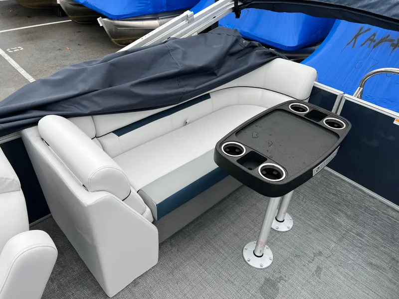 Slide: The Image of 2024 Godfrey SWEETWATER 2286 SB boat interior with seating and table. - 8