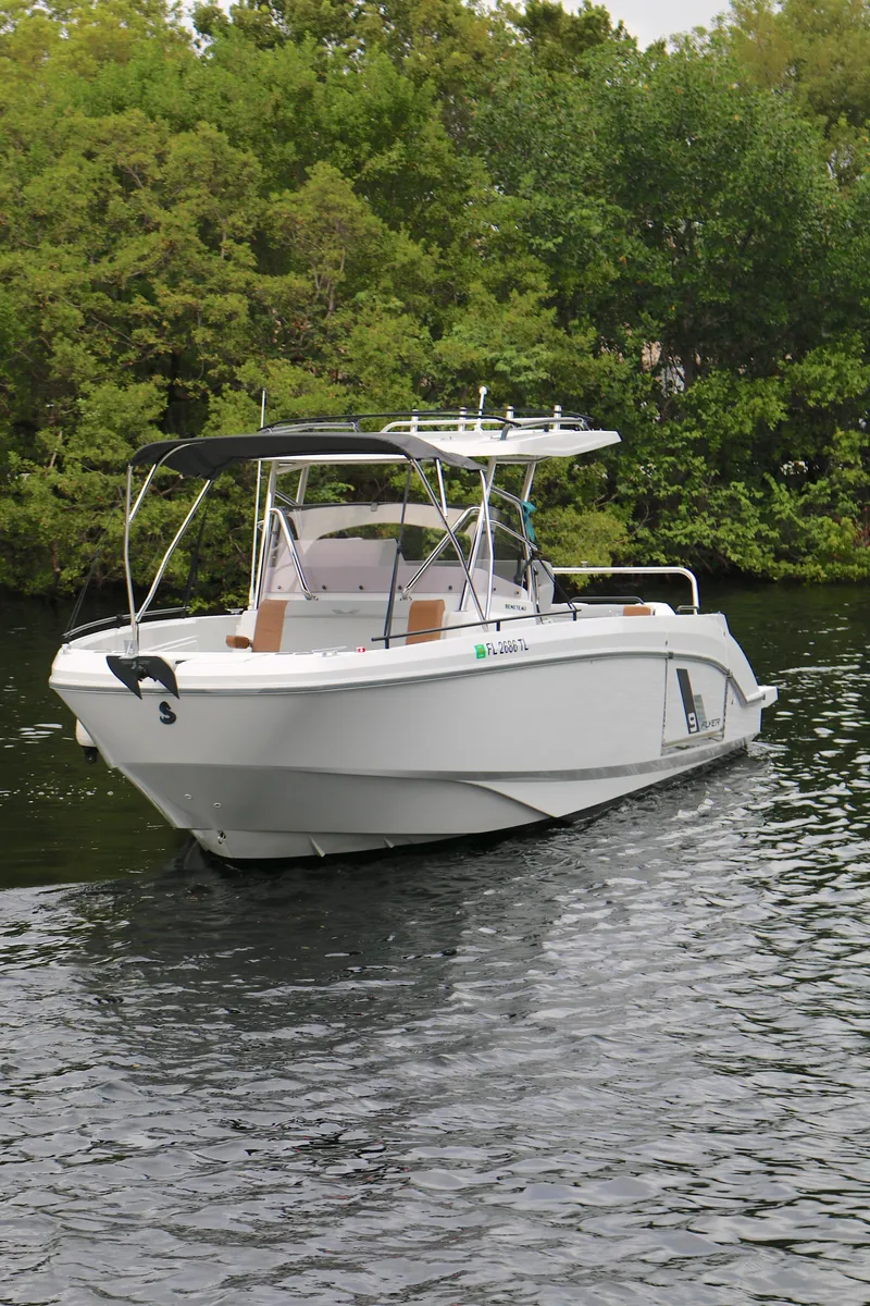 Slide: The Image of 2022 Beneteau FLYER 9 SPACE DECK boat on calm water, surrounded by lush greenery. - 21