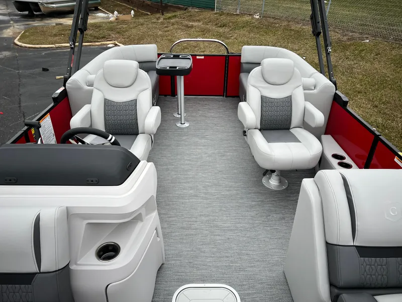 Slide: The Image of 2024 Godfrey SWEETWATER 2286 SB pontoon boat interior with gray seating and red accents. - 10