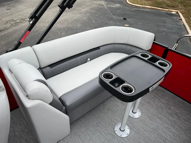 Slide: The Image of 2024 Godfrey SWEETWATER 2286 SB pontoon boat seating area with table and cup holders. - 12