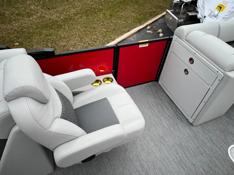 Slide: The Image of 2024 Godfrey SWEETWATER 2286 SB boat interior with plush seating and cup holders. - 15