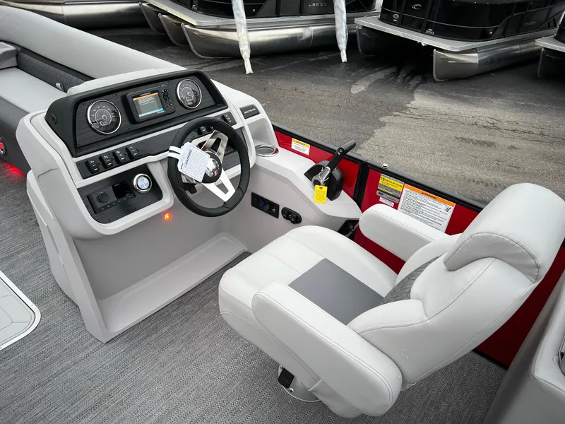 Slide: The Image of 2024 Godfrey SWEETWATER 2286 SB boat cockpit with steering wheel and captain's chair. - 17