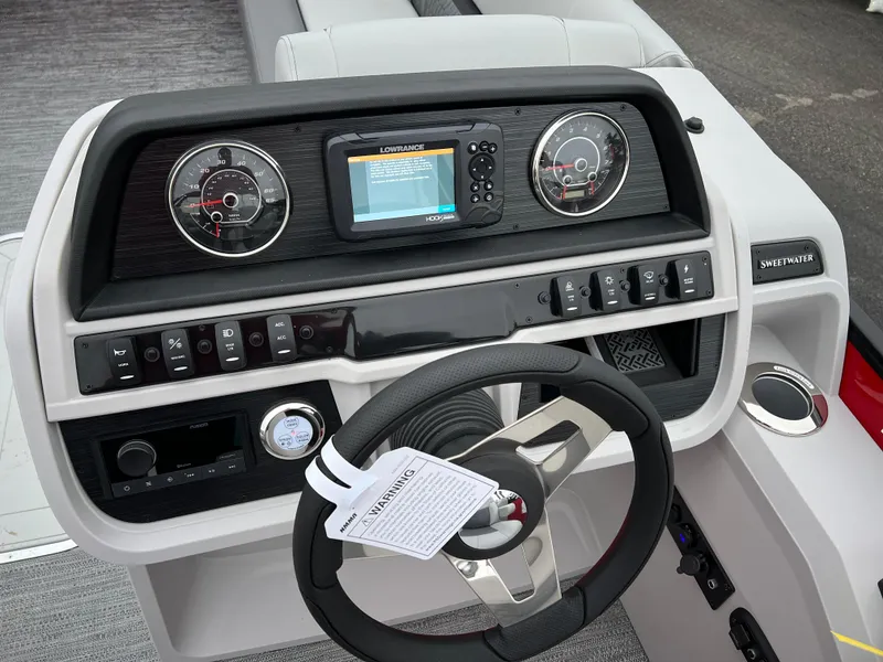 Slide: The Image of 2024 Godfrey SWEETWATER 2286 SB boat dashboard with steering wheel and control panel. - 18