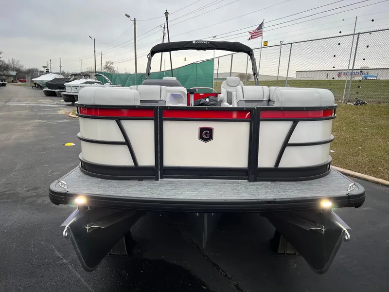 Slide: The Image of 2024 Godfrey SWEETWATER 2286 SB pontoon boat, rear view, parked on pavement. - 2