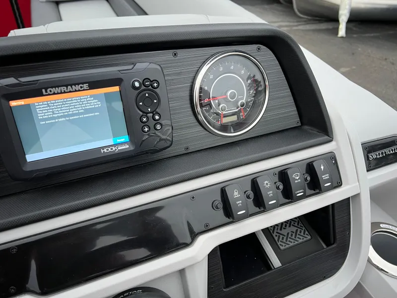 Slide: The Image of Dashboard of 2024 Godfrey SWEETWATER 2286 SB with Lowrance display and control switches. - 20