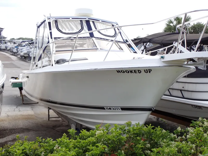 Slide: The Image of 1989 Blackfin 29 Combi boat named Hooked Up docked at a marina. - 1