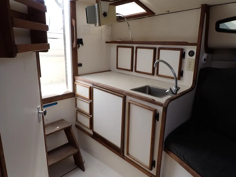 Slide: The Image of 1989 Blackfin 29 Combi boat interior kitchen with sink and cabinets. - 10