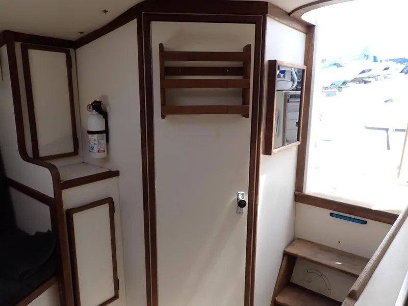 Slide: The Image of Interior of 1989 Blackfin 29 Combi boat with wooden trim and storage cabinets. - 12