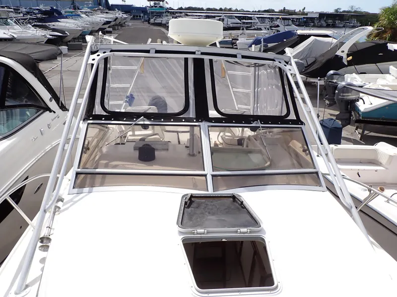 Slide: The Image of 1989 Blackfin 29 Combi boat docked at a marina, view of the cockpit and windshield. - 14