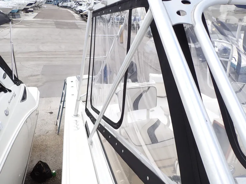 Slide: The Image of 1989 Blackfin 29 Combi boat docked, side view with clear enclosure. - 16