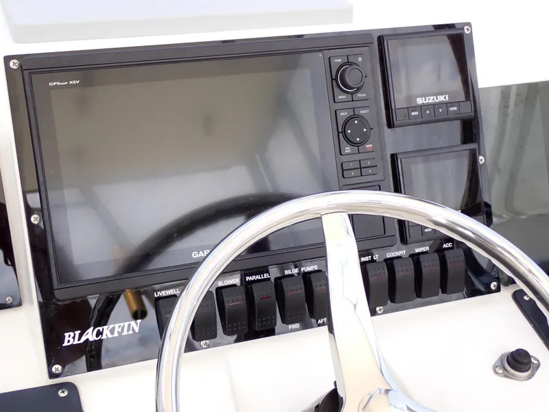 Slide: The Image of 1989 Blackfin 29 Combi boat dashboard with Garmin and Suzuki controls. - 17