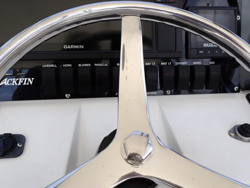 Slide: The Image of Close-up of 1989 Blackfin 29 Combi boat helm with Garmin and Suzuki controls. - 19