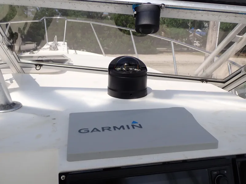 Slide: The Image of 1989 Blackfin 29 Combi boat dashboard with Garmin navigation system and compass. - 22