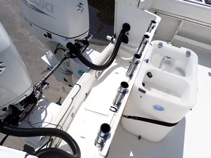 Slide: The Image of 1989 Blackfin 29 Combi boat deck with Suzuki outboard engines and rod holders. - 25
