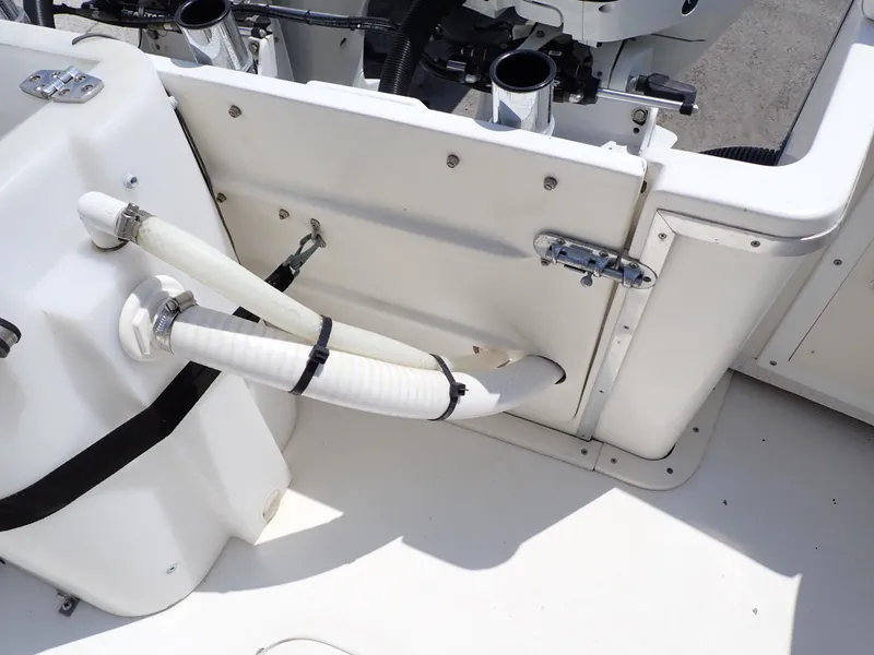 Slide: The Image of 1989 Blackfin 29 Combi boat deck with white hose and storage compartment. - 28