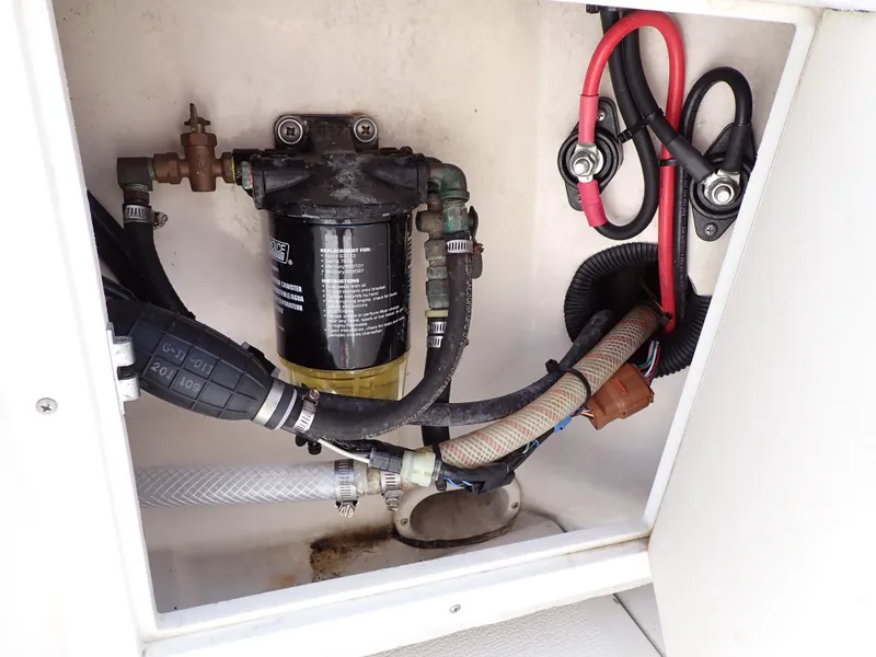 Slide: The Image of 1989 Blackfin 29 Combi engine compartment with fuel filter and wiring. - 30