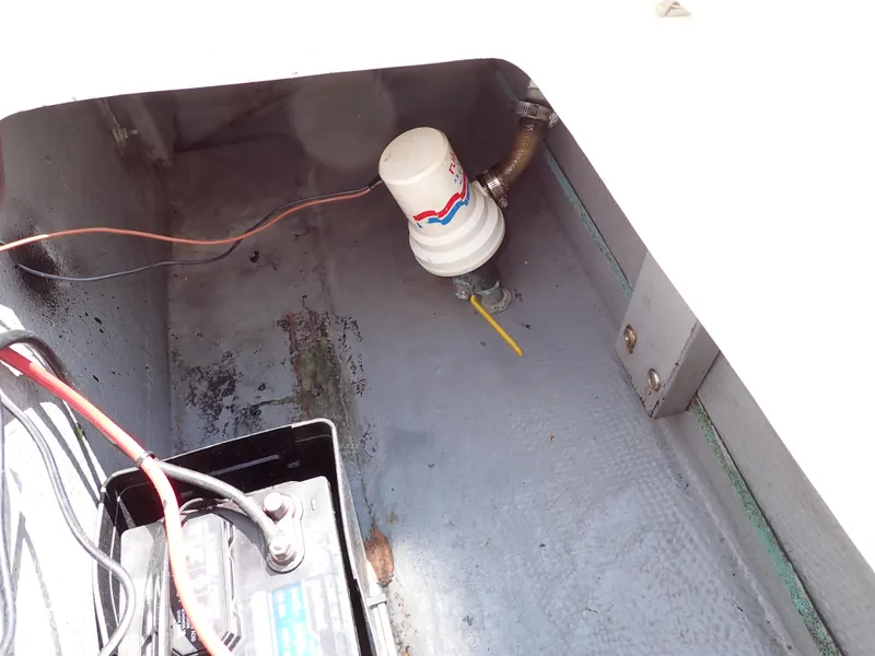 Slide: The Image of 1989 Blackfin 29 Combi engine compartment with battery and fuel filter. - 35