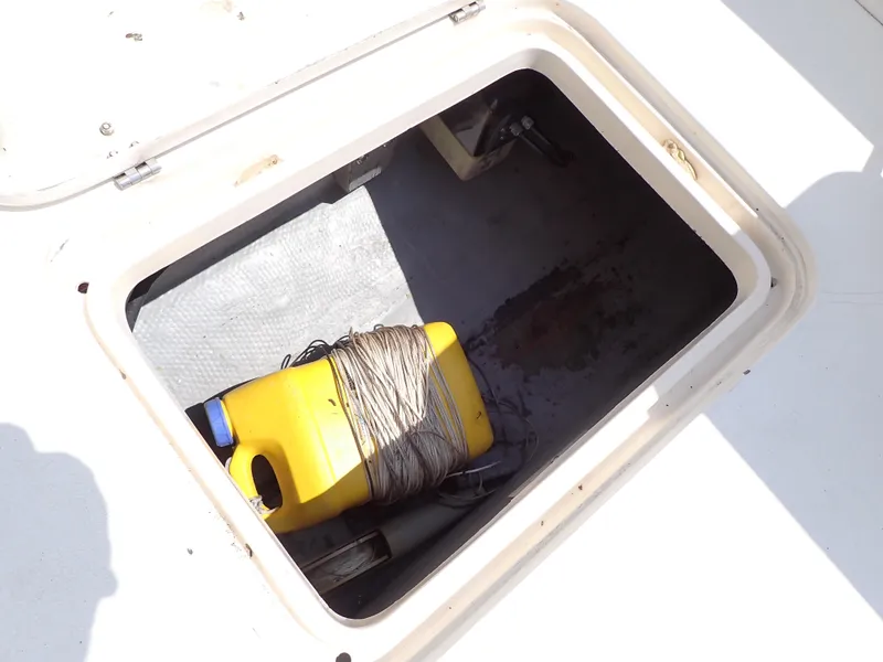 Slide: The Image of Storage compartment of a 1989 Blackfin 29 Combi boat with yellow container. - 37