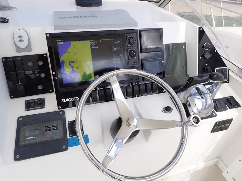 Slide: The Image of 1989 Blackfin 29 Combi boat dashboard with Garmin navigation system and steering wheel. - 4