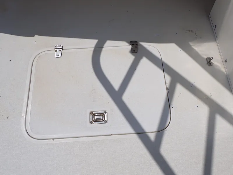 Slide: The Image of 1989 Blackfin 29 Combi deck hatch with metal latch and hinges. - 40