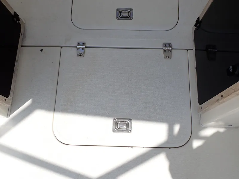 Slide: The Image of 1989 Blackfin 29 Combi boat storage compartments with latches. - 42