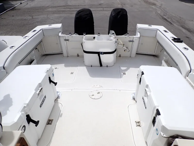Slide: The Image of 1989 Blackfin 29 Combi boat deck with storage compartments and covered engines. - 6