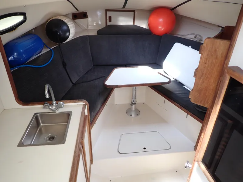Slide: The Image of Interior of 1989 Blackfin 29 Combi boat with kitchenette, seating area, and table. - 8