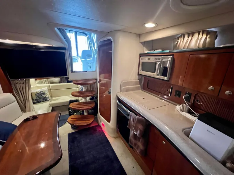 Slide: The Image of Interior of 2007 Sea Ray 320 Sundancer repowered, featuring kitchen and seating area. - 1