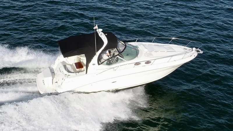Slide: The Image of 2007 Sea Ray 320 Sundancer repowered cruising on open water. - 12