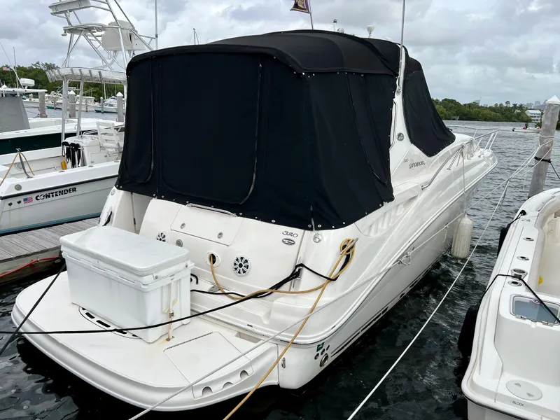 Slide: The Image of 2007 Sea Ray 320 Sundancer repowered, docked with black canvas cover. - 13