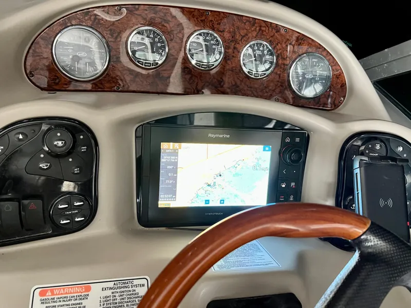 Slide: The Image of Dashboard of a 2007 Sea Ray 320 Sundancer repowered boat with navigation system. - 19