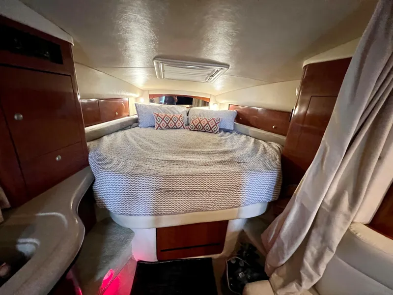 Slide: The Image of 2007 Sea Ray 320 Sundancer repowered cabin with bed and storage. - 21
