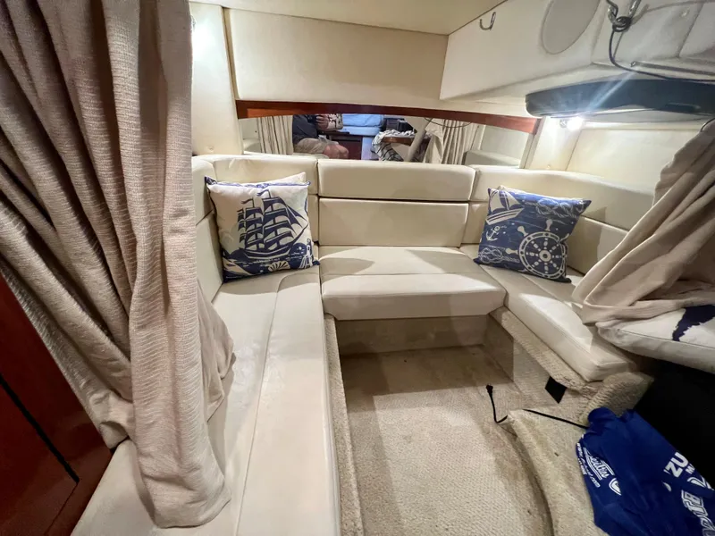 Slide: The Image of Interior of 2007 Sea Ray 320 Sundancer repowered, featuring cozy seating and nautical-themed pillows. - 22